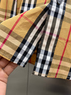 Plaid shirt cuffs with two button placket and stitched edge