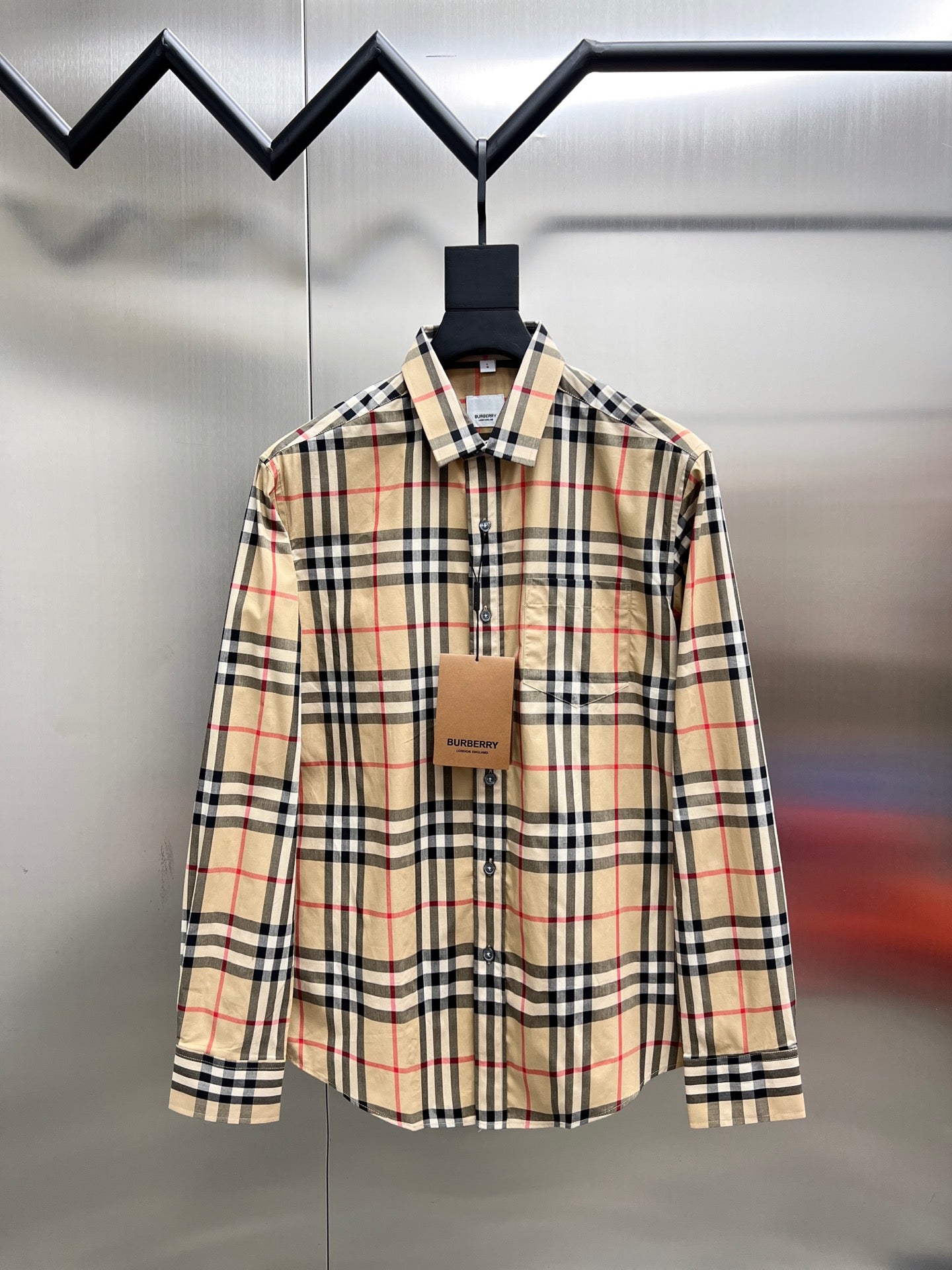 Burberry long-sleeve plaid button-up shirt on hanger, front view