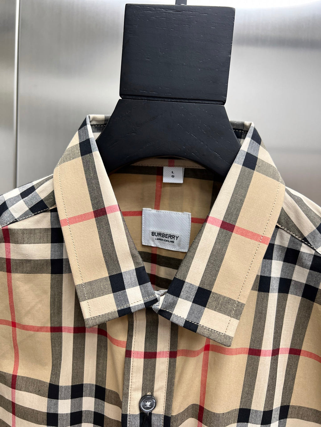 Burberry plaid shirt collar and placket, button detail close-up