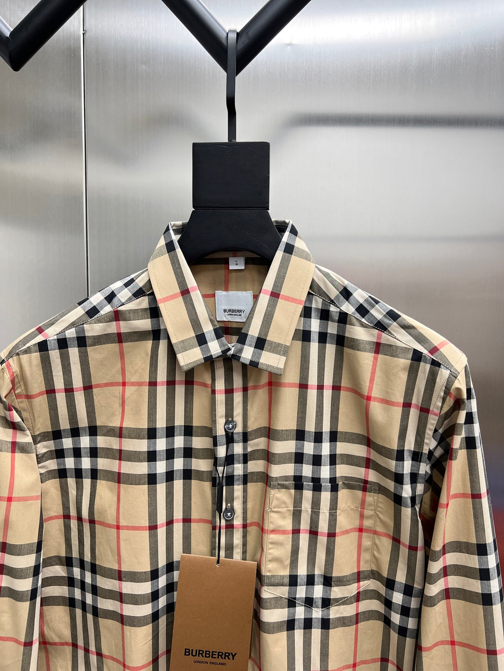 Burberry plaid button-up shirt with pointed collar, close-up front