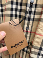 Burberry plaid shirt hang tag attached near button placket
