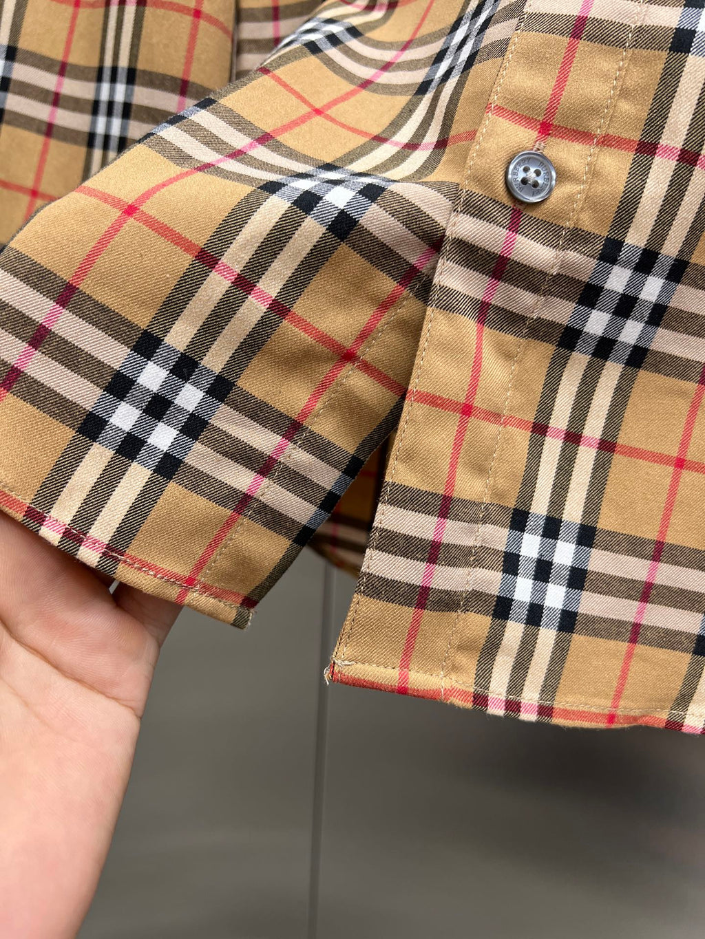 Burberry check shirt cuff detail with button and plaid pattern