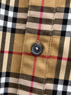 Burberry check shirt button close-up on plaid fabric