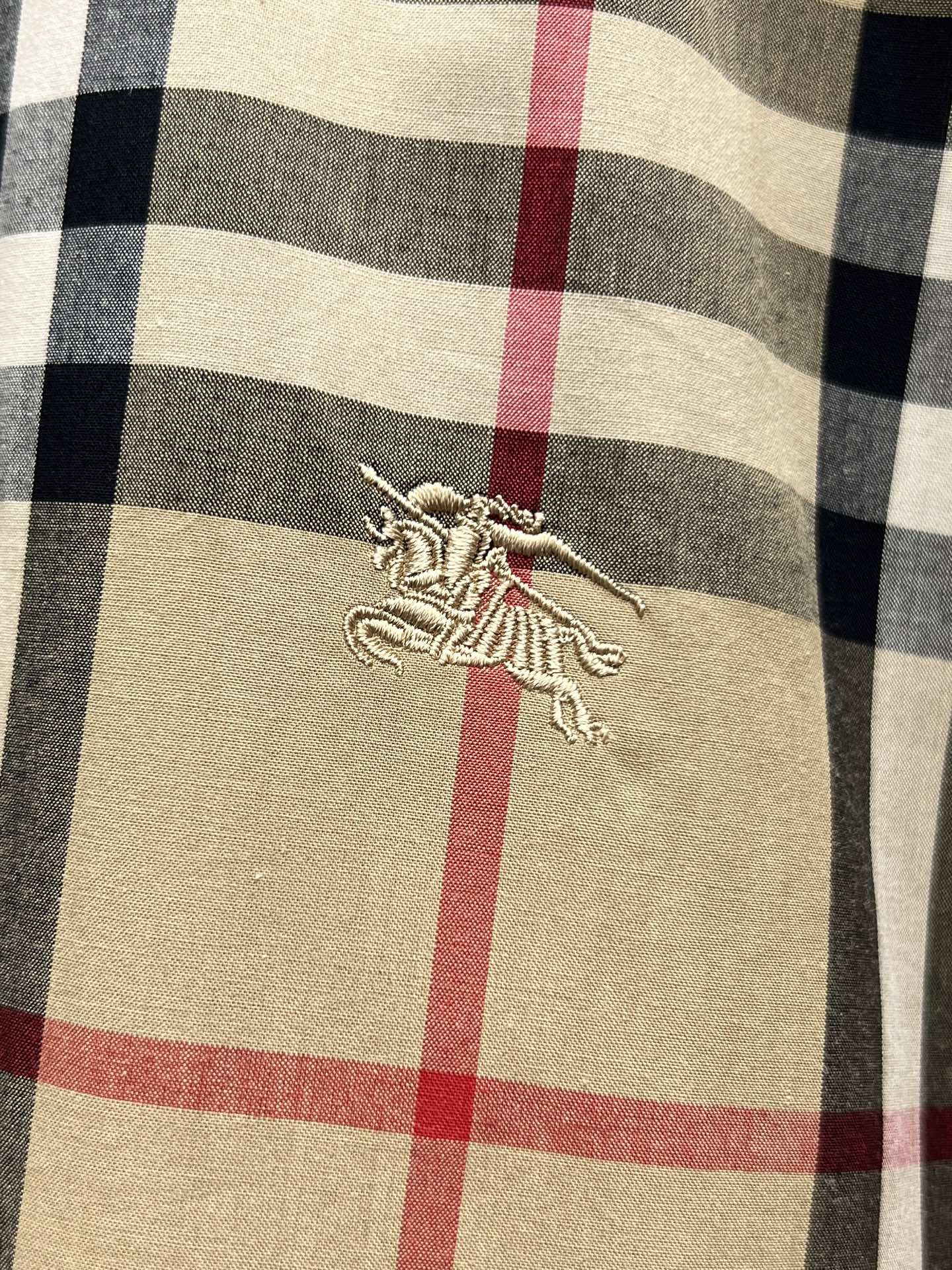 Burberry plaid shirt chest logo embroidery on tan fabric with red and navy checks
