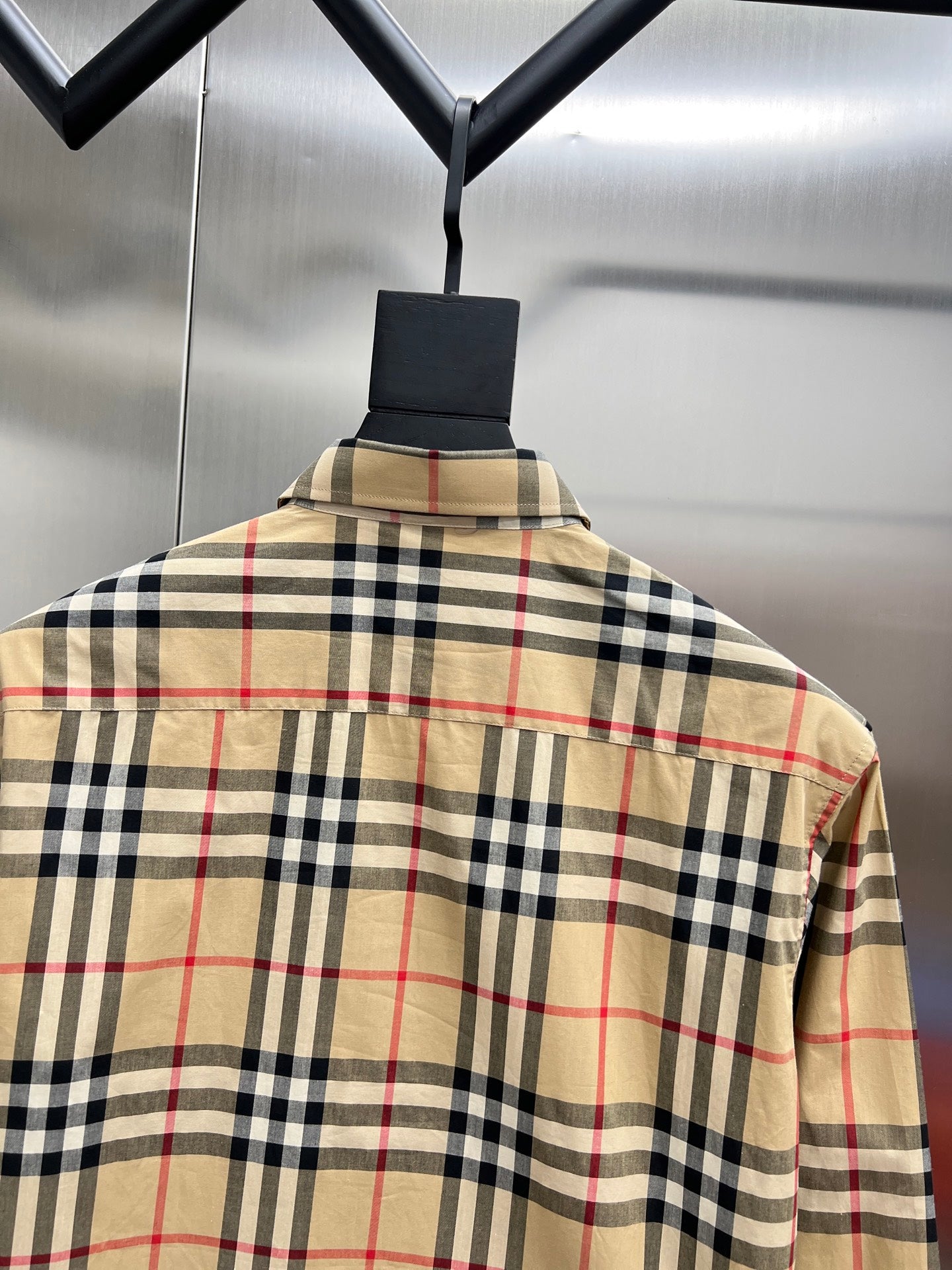 Plaid long-sleeve shirt on hanger, beige navy and red check, back view collar