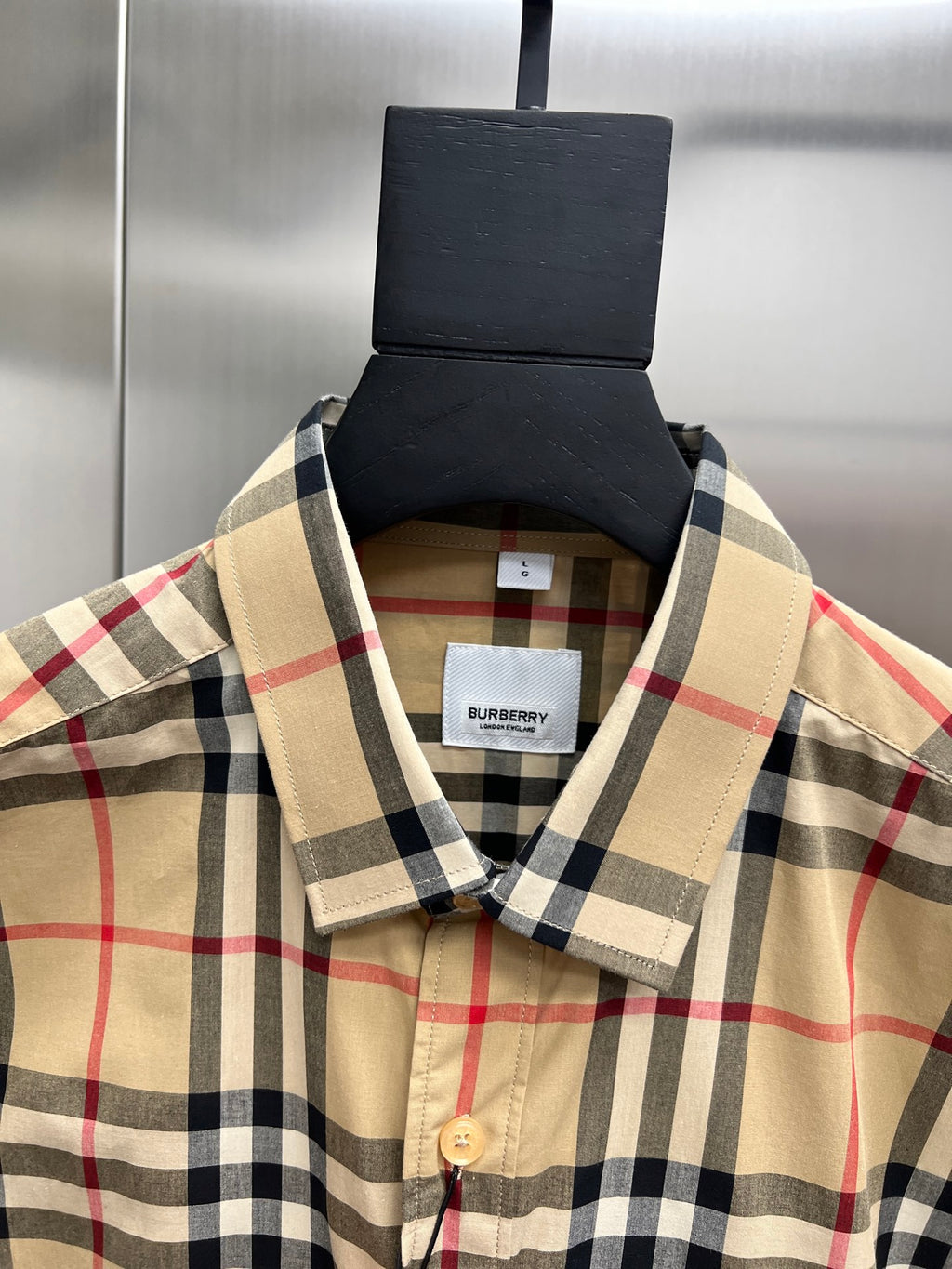 Burberry long-sleeve plaid button-up shirt neckline close-up, tan and navy check
