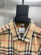 Burberry long-sleeve plaid button-up shirt neckline close-up, tan and navy check