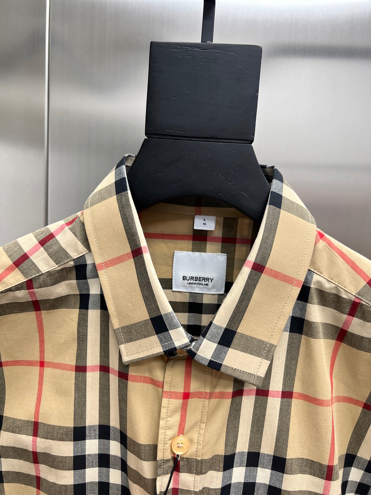 Burberry long-sleeve plaid button-up shirt neckline close-up, tan and navy check