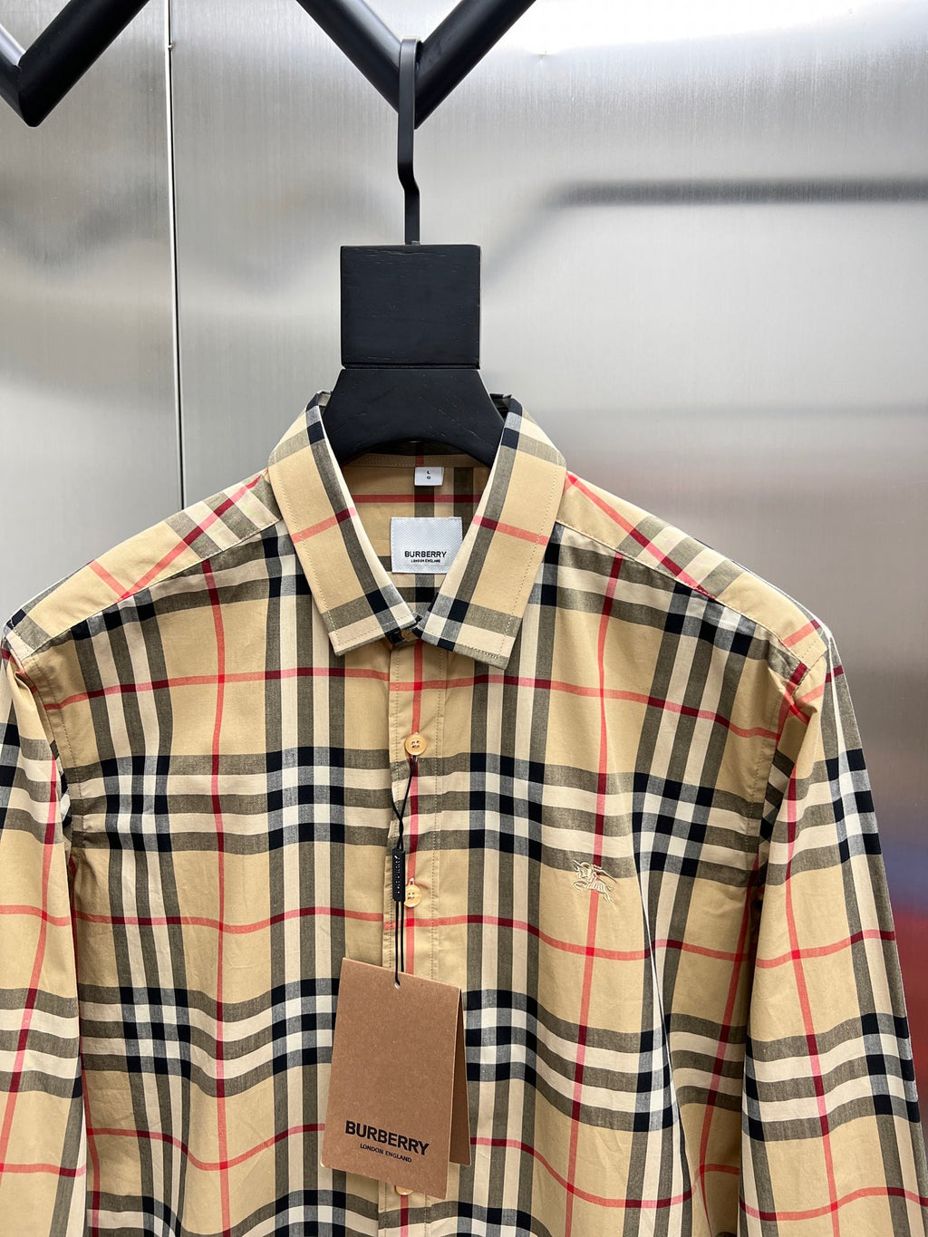 Burberry long-sleeve plaid button-up shirt close-up, front with collar and buttons