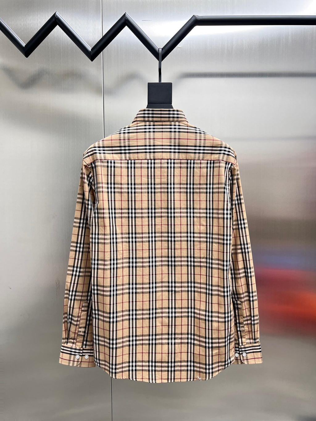 Plaid long-sleeve button-up shirt shown from the back on a hanger