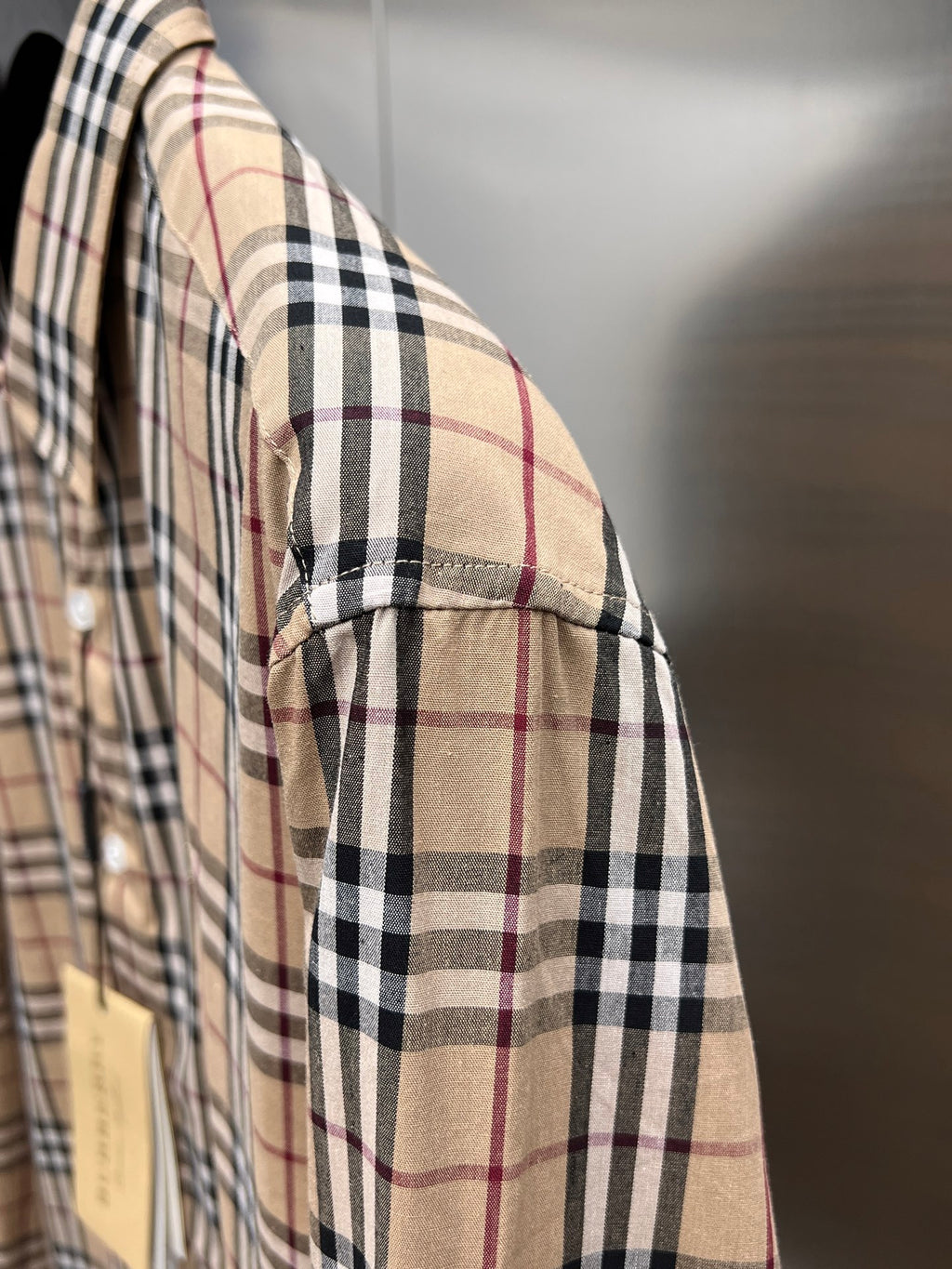 Plaid long-sleeve shirt side view with cuff seam detail