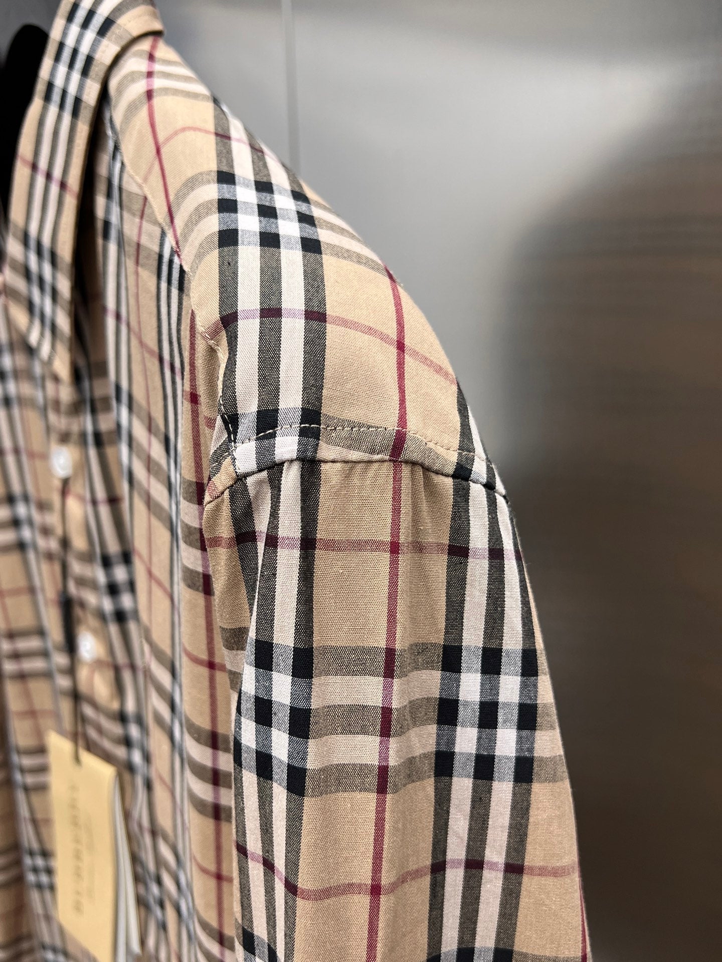 Plaid long-sleeve shirt side view with cuff seam detail