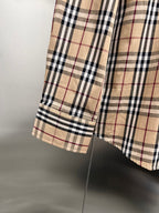 Plaid shirt hem detail with side seam and layered fabric panel