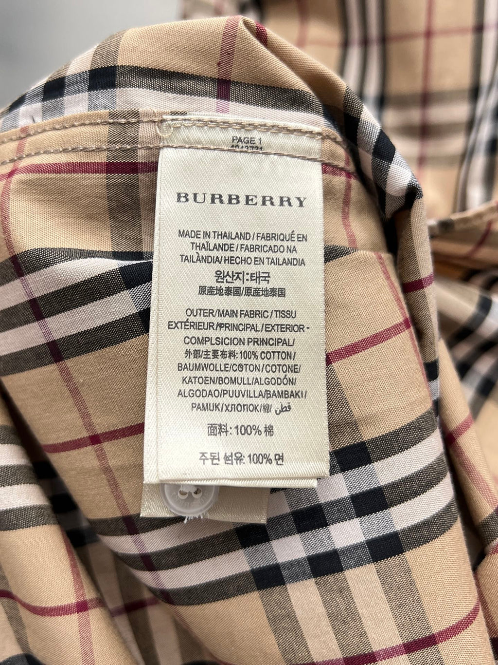 Burberry plaid shirt neck label with fabric composition and care text
