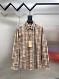 Plaid button-up shirt with long sleeves and front button placket, on a hanger