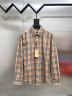 Plaid button-up shirt with long sleeves and front button placket, on a hanger