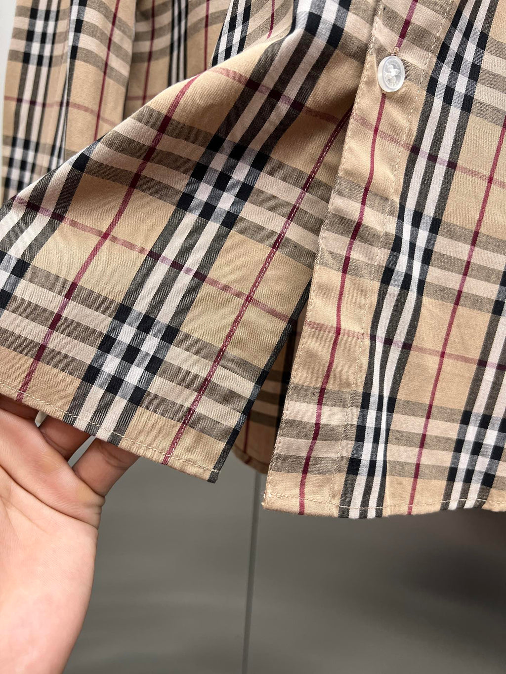 Plaid shirt cuff and sleeve edge with button detail