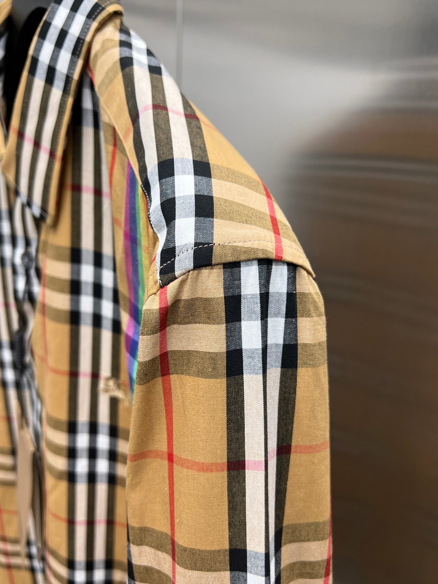 Plaid long-sleeve shirt side view with shoulder seam and sleeve placket