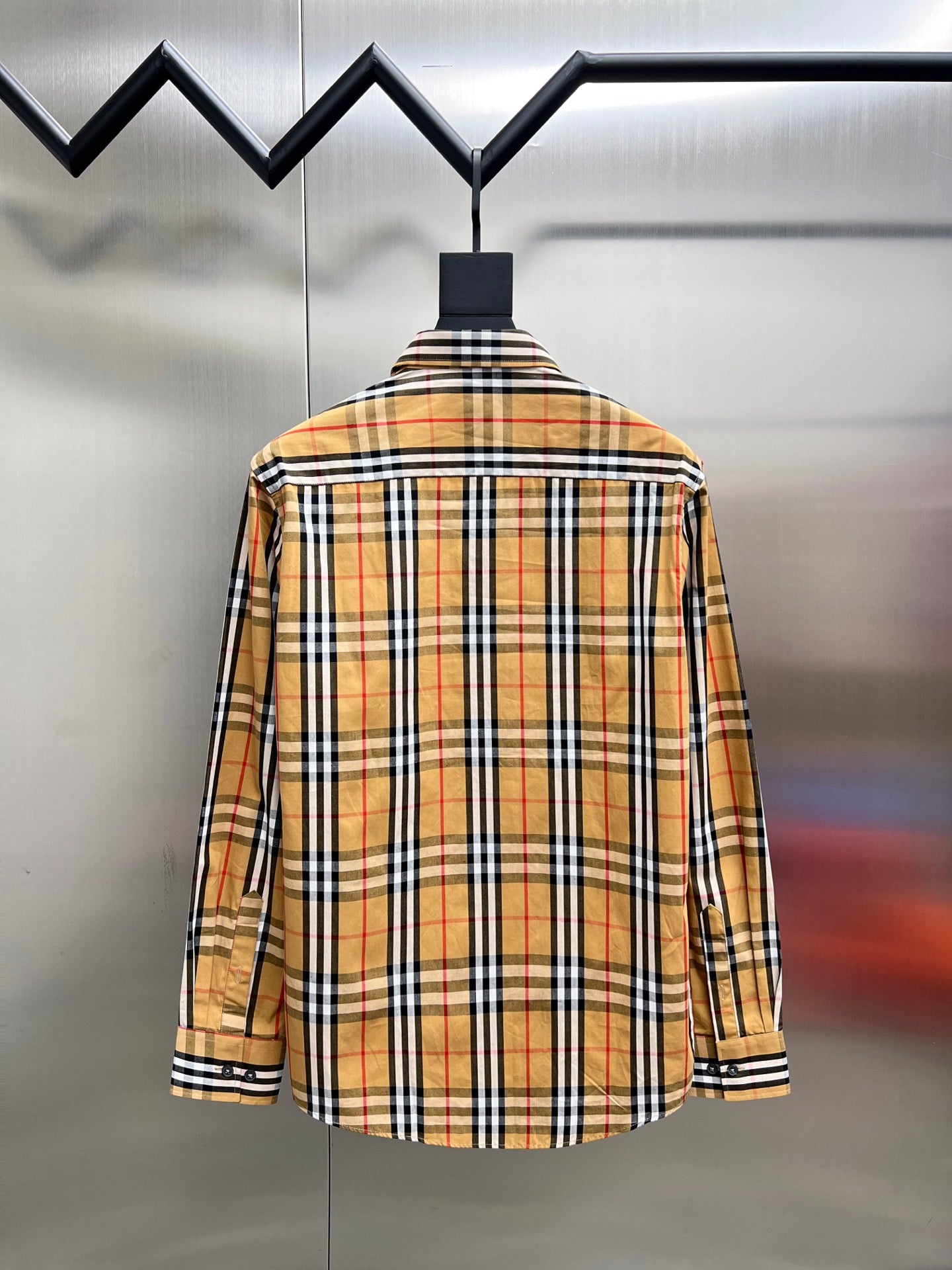 Plaid long-sleeve button-up shirt, back view with buttoned yoke and cuff stripes