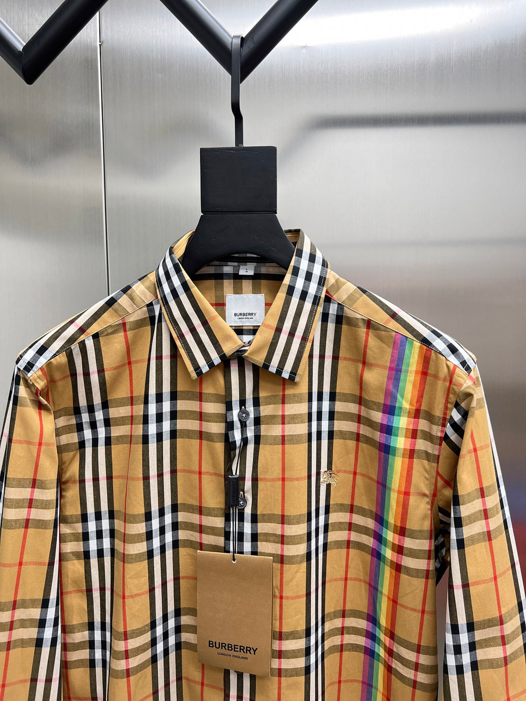 Plaid button-up shirt close-up at chest, spread collar and front placket buttons