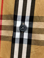 Plaid shirt close-up of round dark button on front placket
