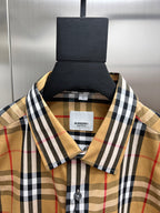 Plaid shirt collar close-up with brand label and buttoned neckline