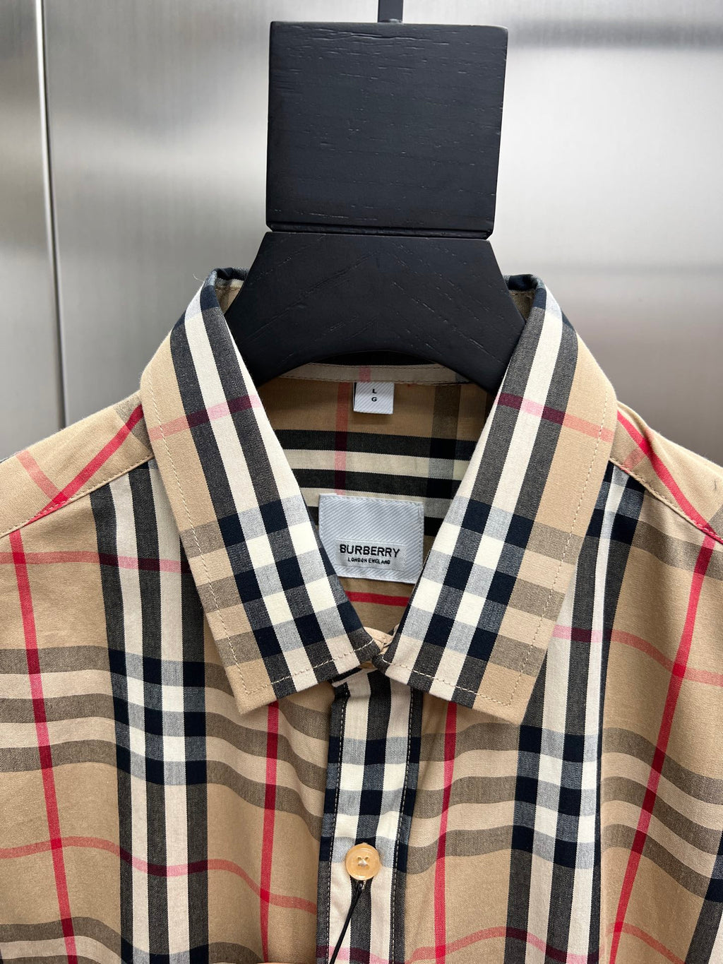 Plaid button-up shirt collar and front placket with buttons, Burberry neck label