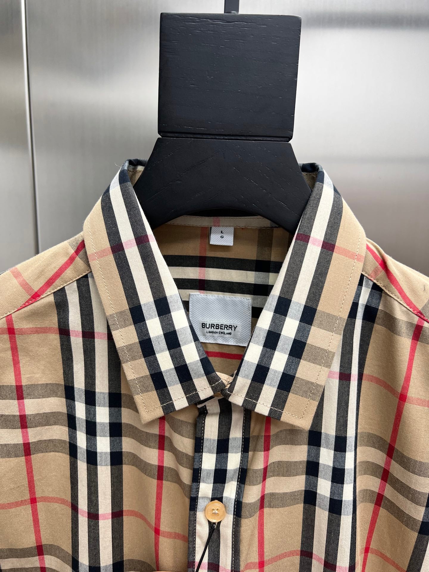 Plaid button-up shirt collar and front placket with buttons, Burberry neck label