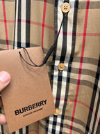 Shirt placket and neckline with buttons, plaid check in tan/black/red, Burberry tag