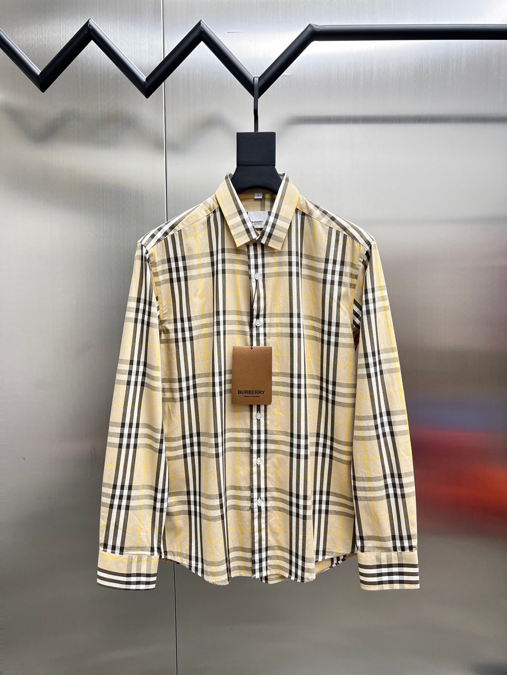 Long-sleeve plaid button-up shirt with pointed collar, cream base, black and yellow stripes