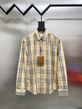 Long-sleeve plaid button-up shirt with pointed collar, cream base, black and yellow stripes