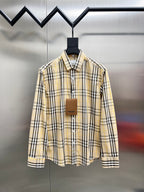 Long-sleeve plaid button-up shirt with pointed collar, cream base, black and yellow stripes