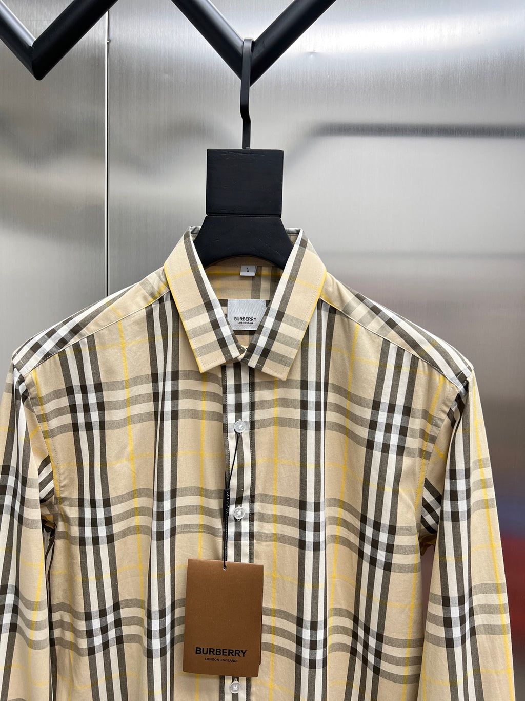 Plaid long-sleeve button-up shirt with pointed collar, cream base, black and yellow stripes