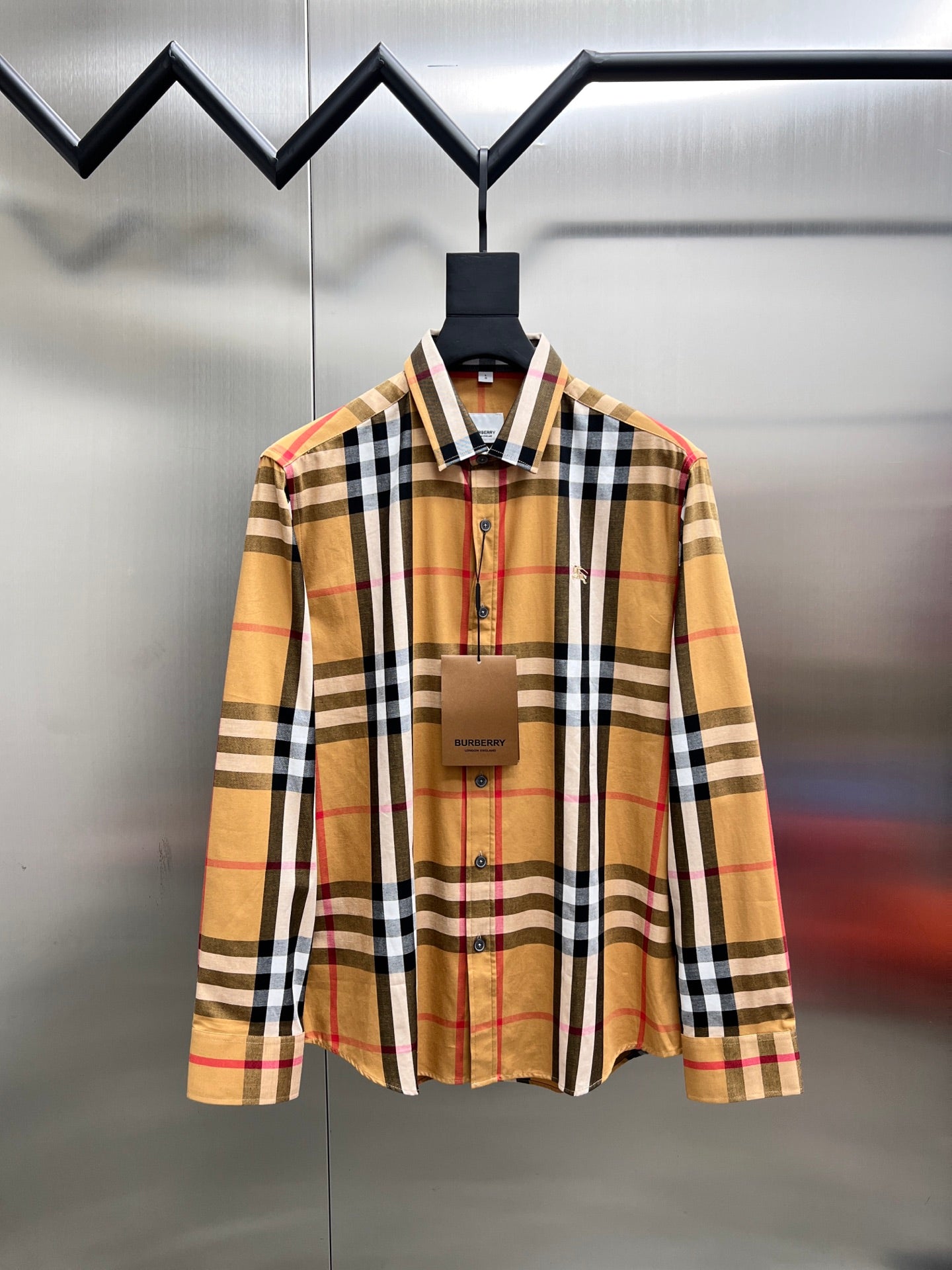 Long-sleeve plaid shirt on hanger, button-front and spread collar