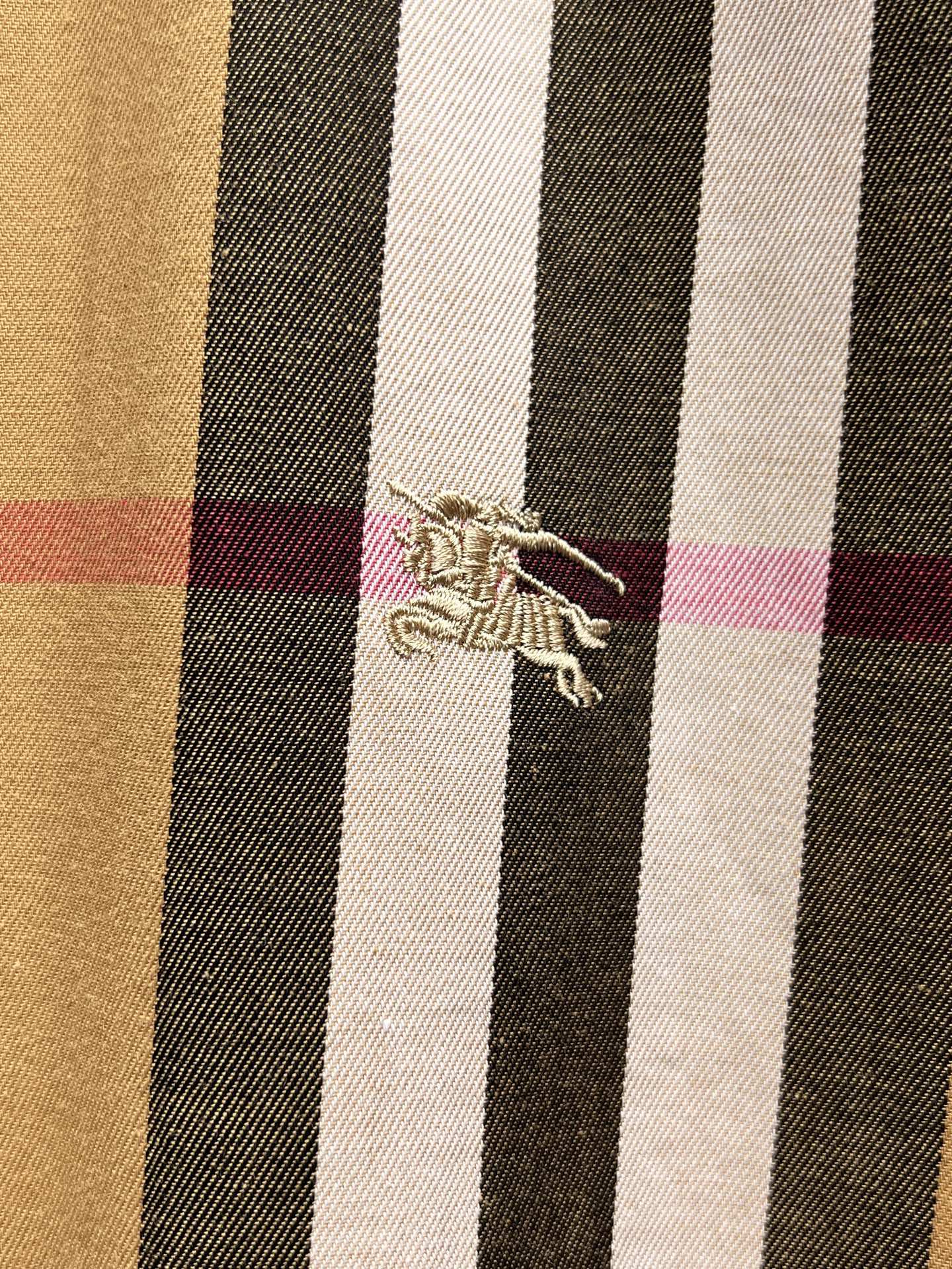 Embroidered logo on plaid long-sleeve shirt fabric panel