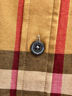 Round button on plaid long-sleeve shirt front with stitched placket
