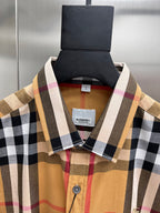 Long-sleeve plaid shirt collar close-up with brand tag and button placket