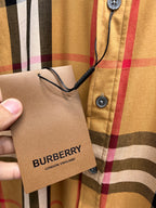 Plaid long-sleeve shirt with hang tag held near button placket
