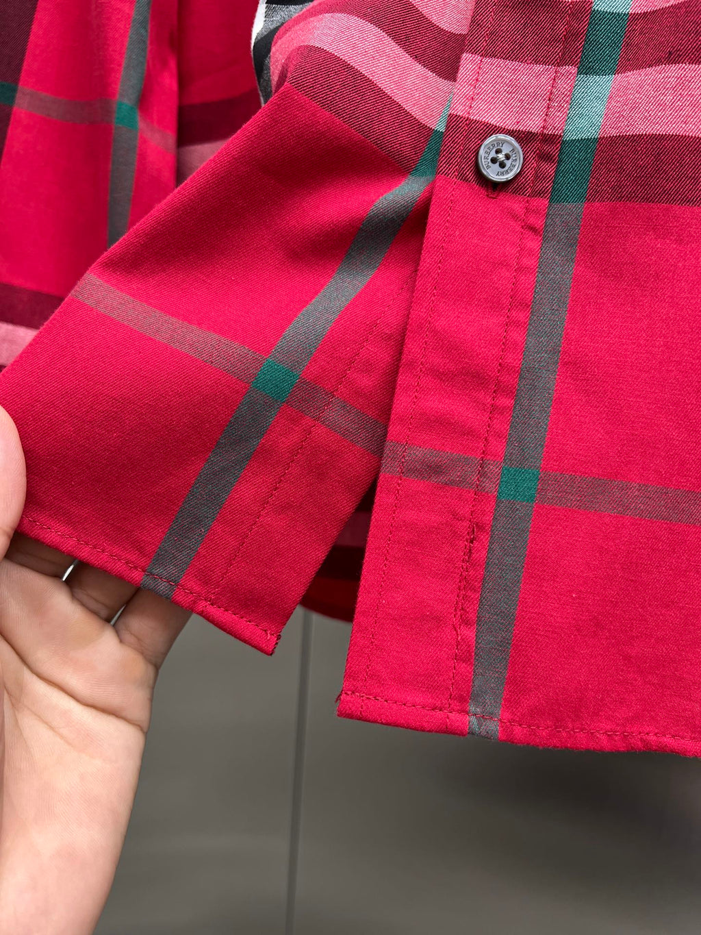 Red plaid long-sleeve shirt cuff with button and hem