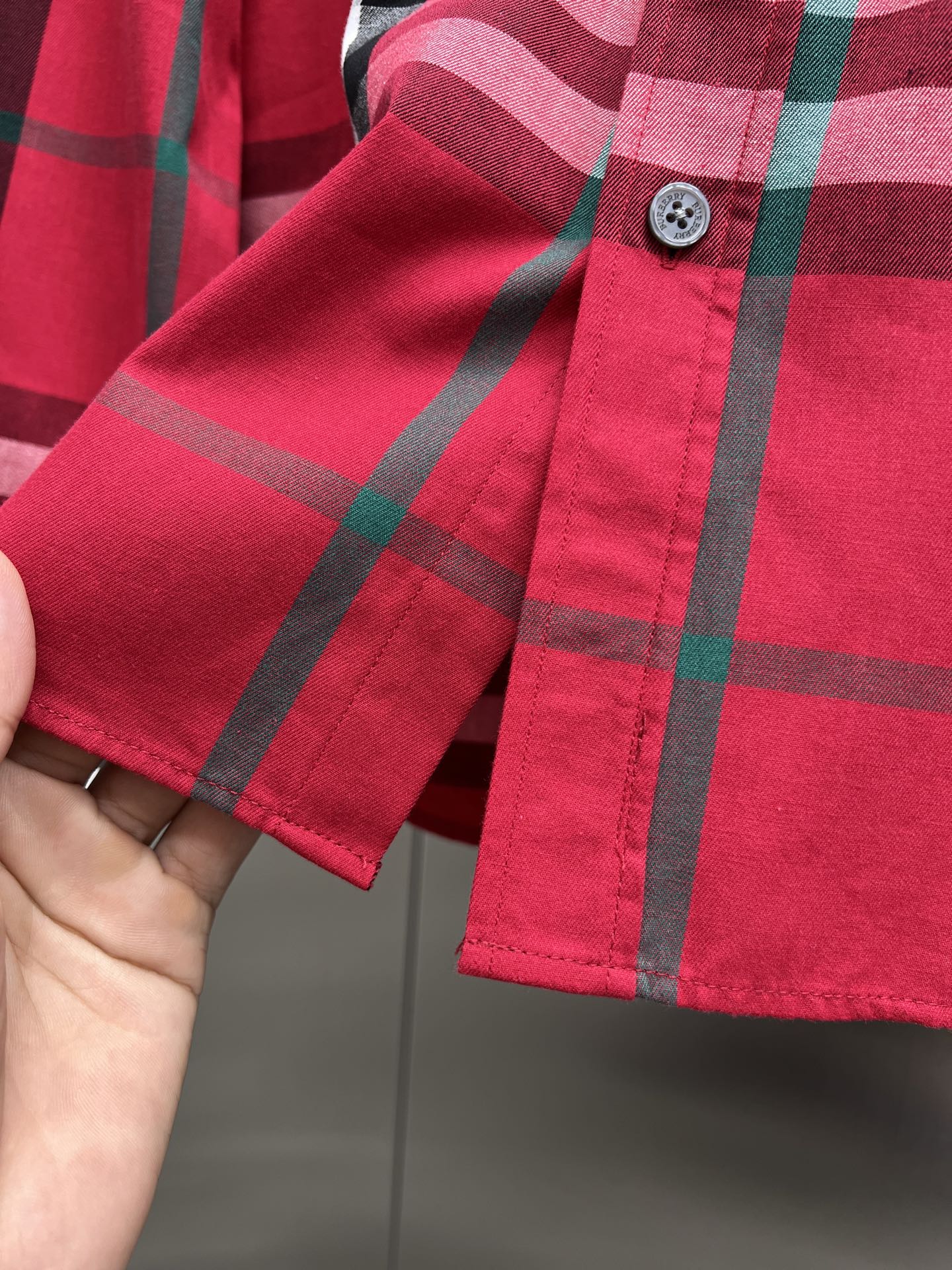 Red plaid long-sleeve shirt cuff with button and hem