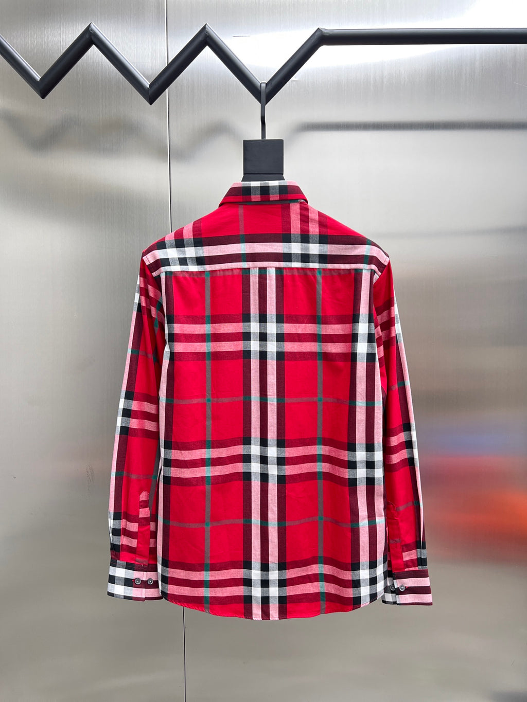 Red and black plaid long-sleeve button-up shirt, back view with yoke seam