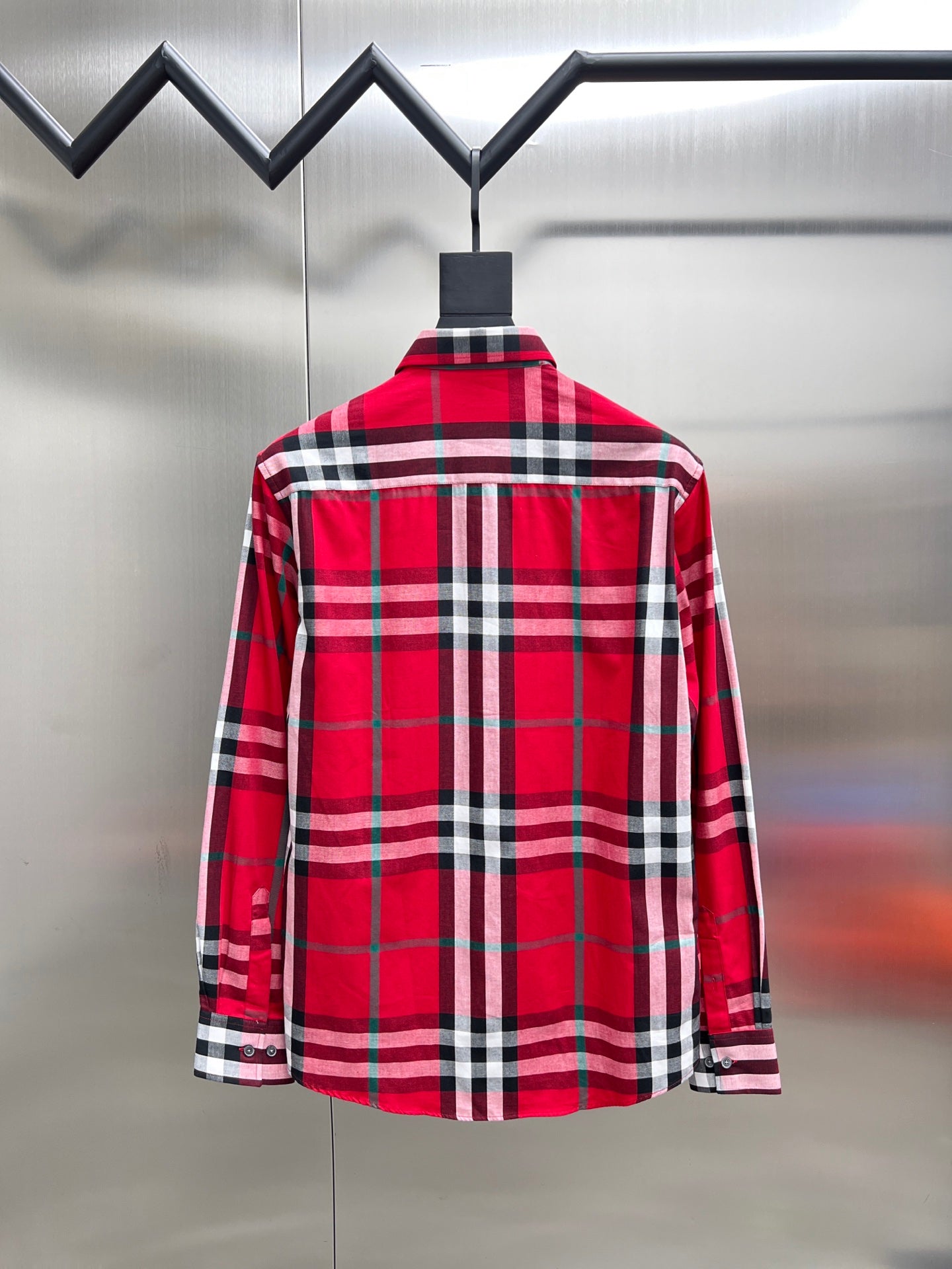 Red and black plaid long-sleeve button-up shirt, back view with yoke seam