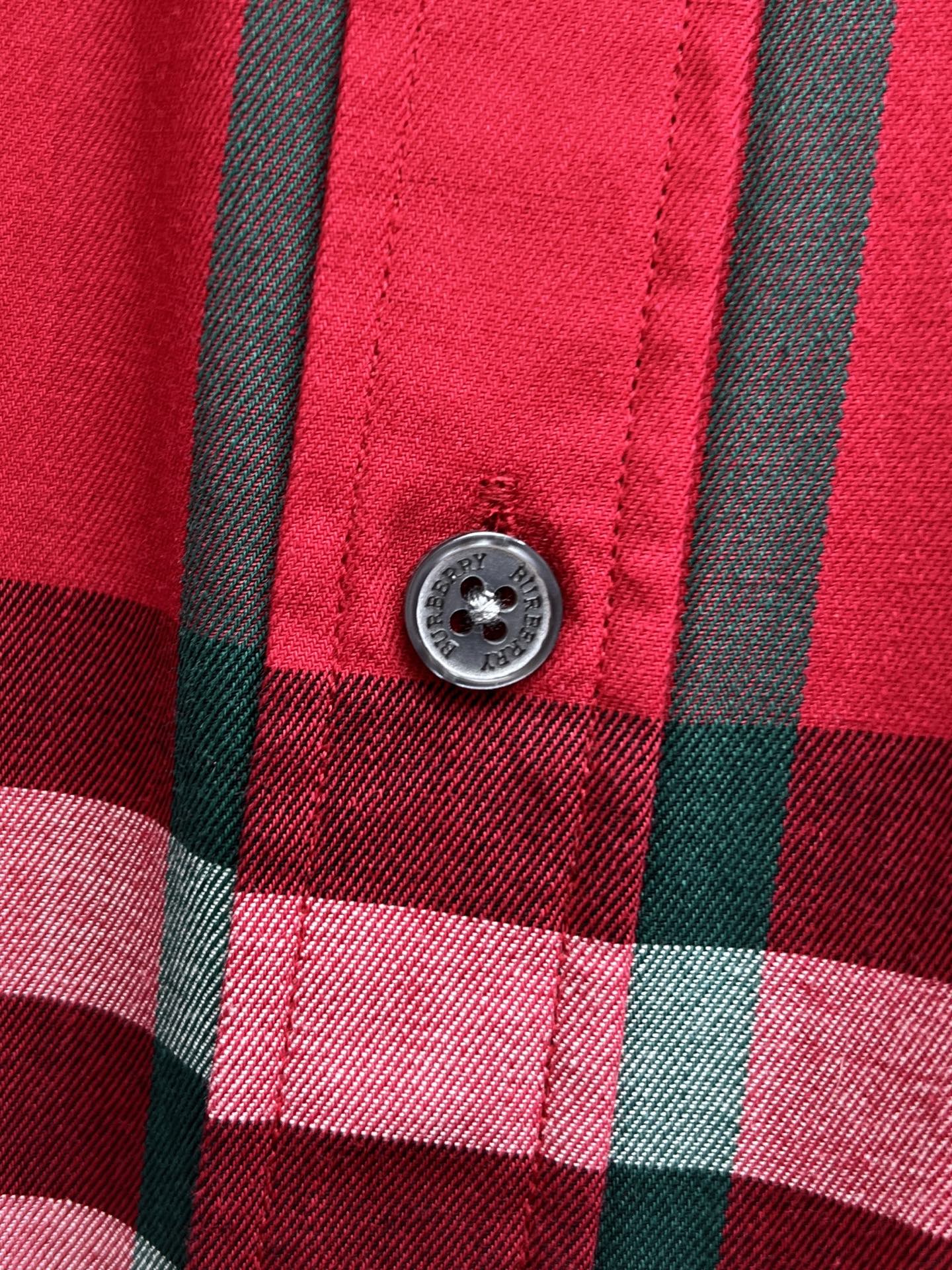 Round button on red and black plaid button-up shirt placket