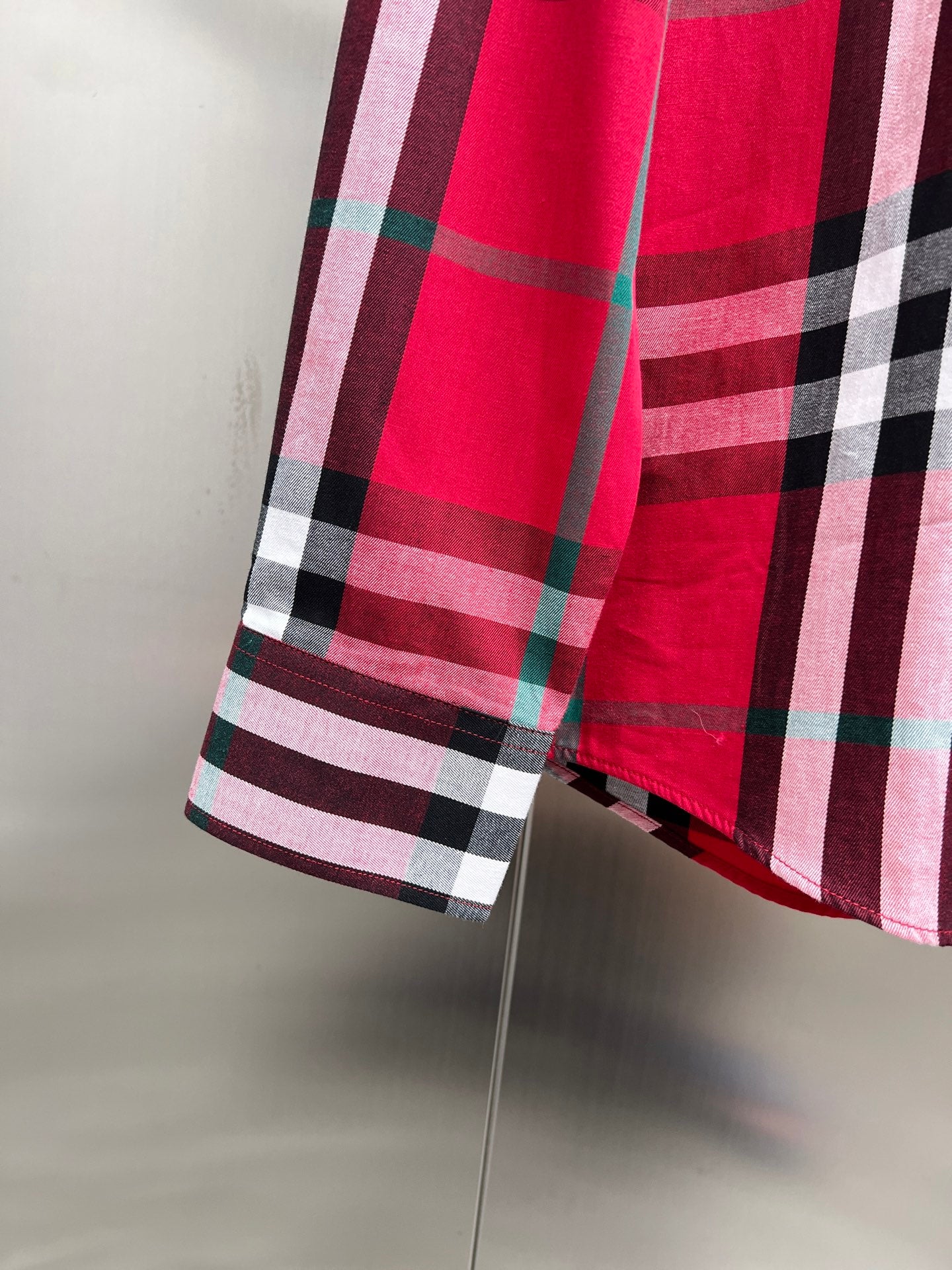 Red and black plaid shirt hem with long sleeves and side seam