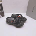Black Balenciaga sandals featuring bow detail, heart patch accents, and textured outsole