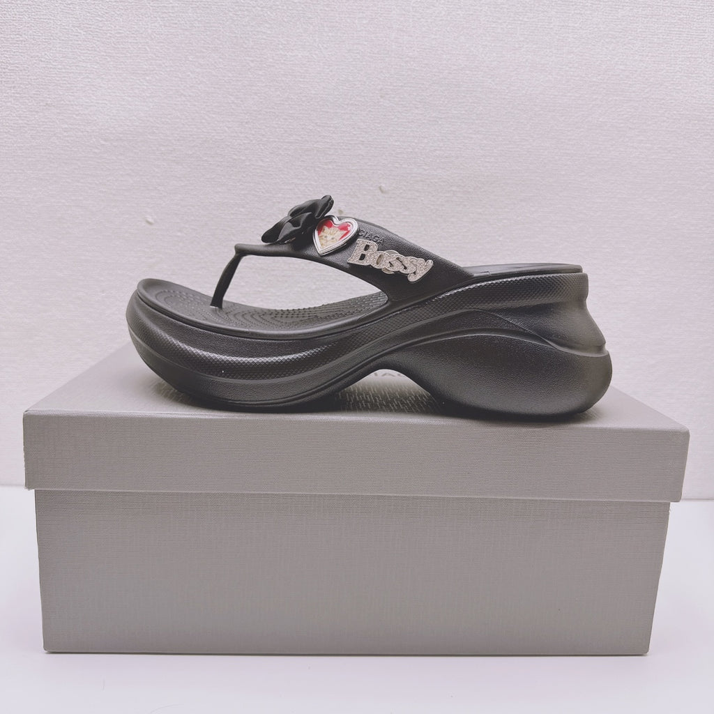 Black Balenciaga sandals with bow detail, heart patches, and thick contoured sole
