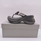 Black Balenciaga sandals with bow detail, heart patches, and thick contoured sole