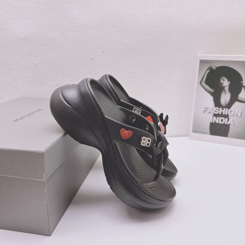 Black Balenciaga sandals with bow strap and heart patch on textured platform sole