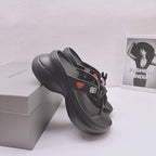 Black Balenciaga sandals with bow strap and heart patch on textured platform sole