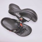 Black Balenciaga sandals with heart patch accents and bow strap on contoured sole